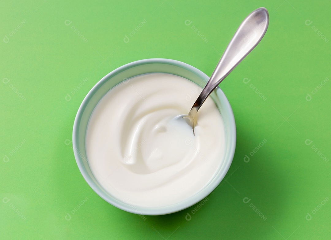 Iogurte em uma tigela no fundo verde