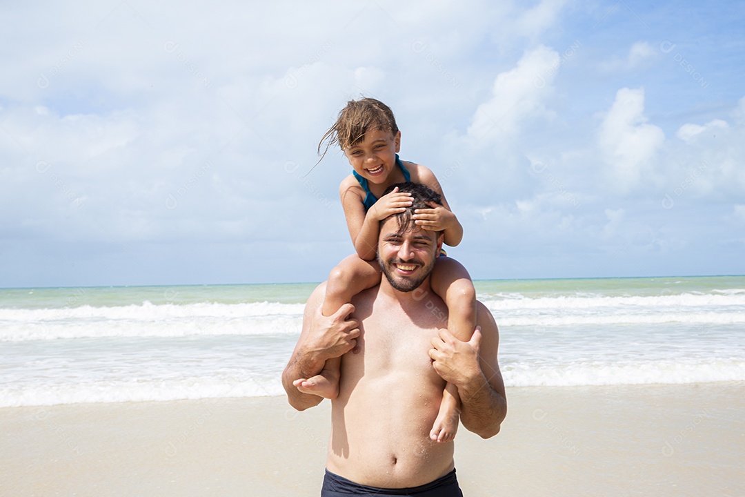 Pai e filha brincando na praia