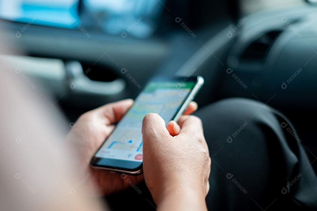 Mão de uma mulher usando smartphone enquanto está sentado no carro para entretenimento durante engarrafamentos ou durante uma longa viagem