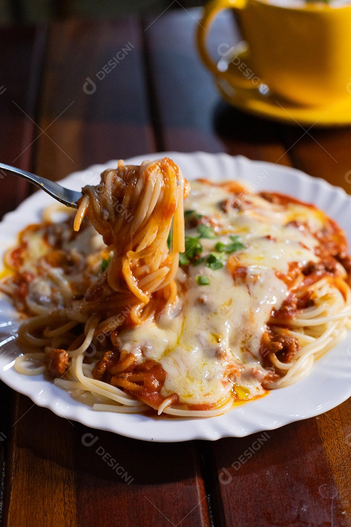 Um prato de espaguete gratinado com queijo