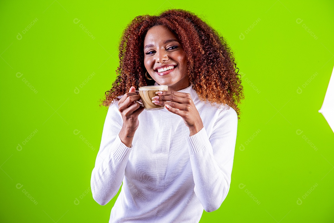Mulher segurando xícara com cappuccino em fundo verde