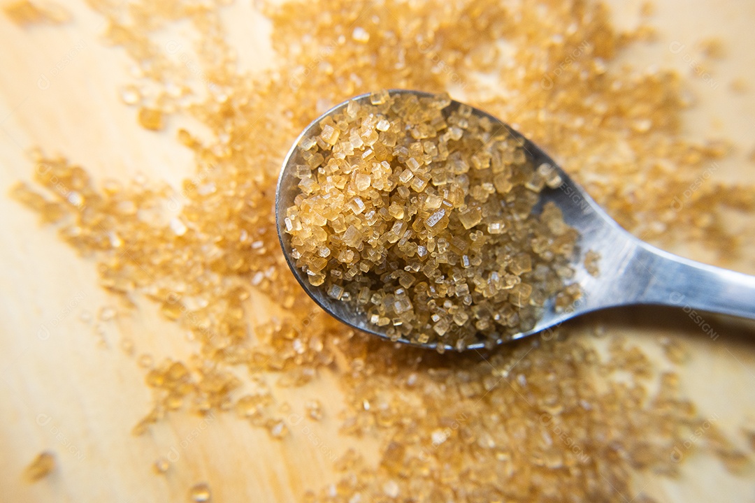 Macro de açúcar orgânico em uma colher na mesa de madeira