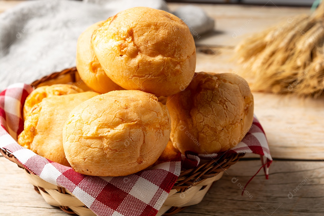 Pão de queijo em mesa de madeira com café preto
