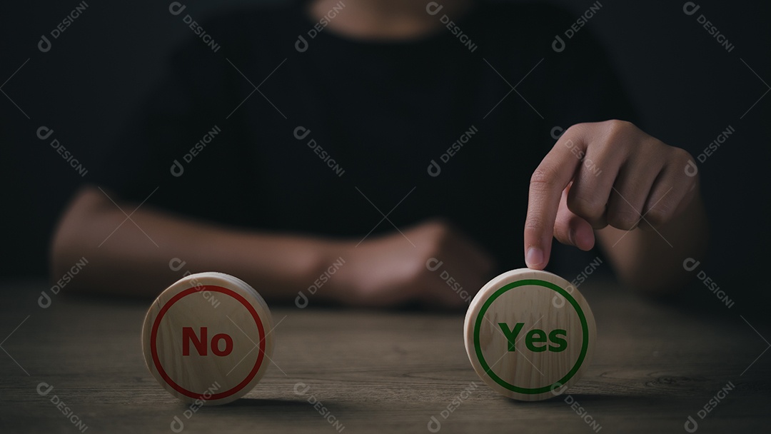 Fechar a imagem da mão do homem colocando dados de madeira com sinais de sim e não