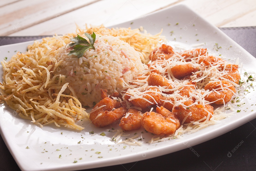 Camarão empanado com arroz, batatas fritas e grana padano