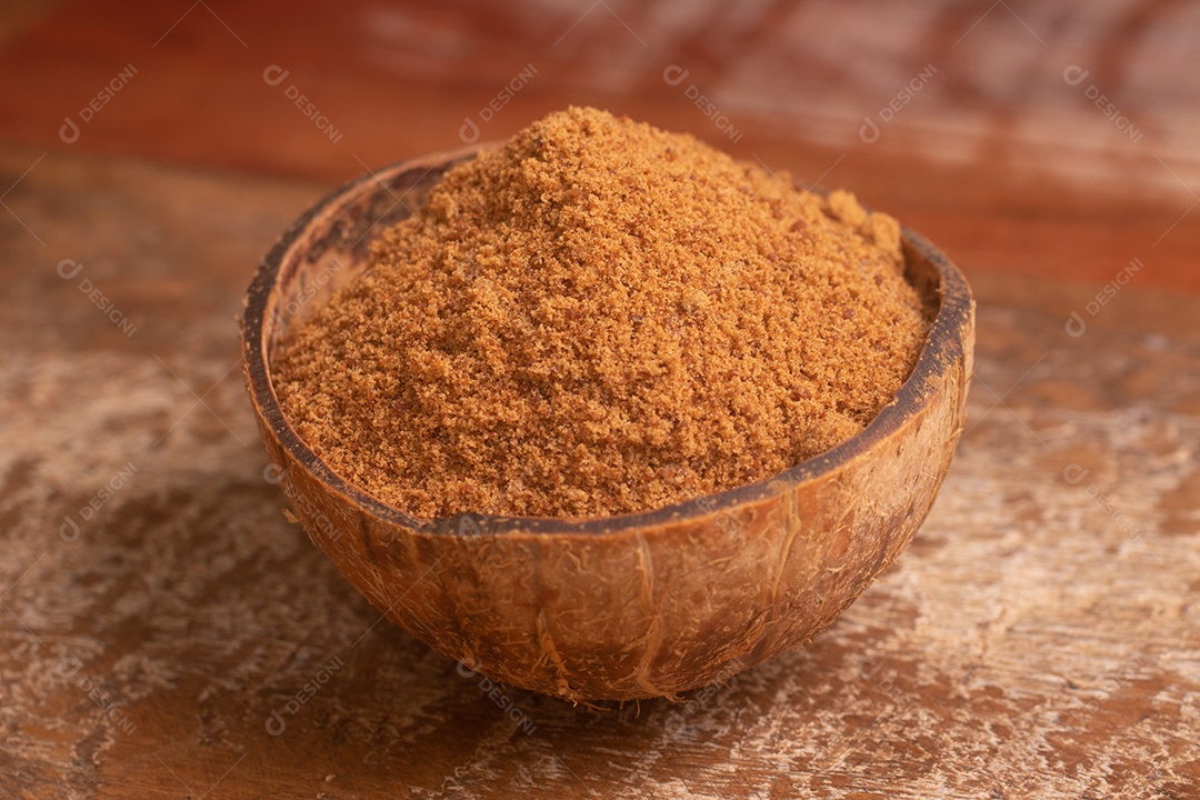 Açúcar de coco em uma tigela sobre uma mesa de madeira