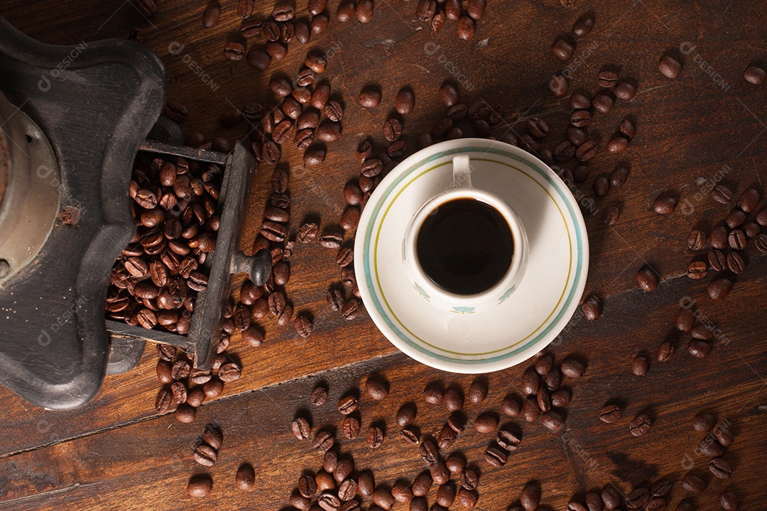 Moedor de café antigo, grãos de café e xícara