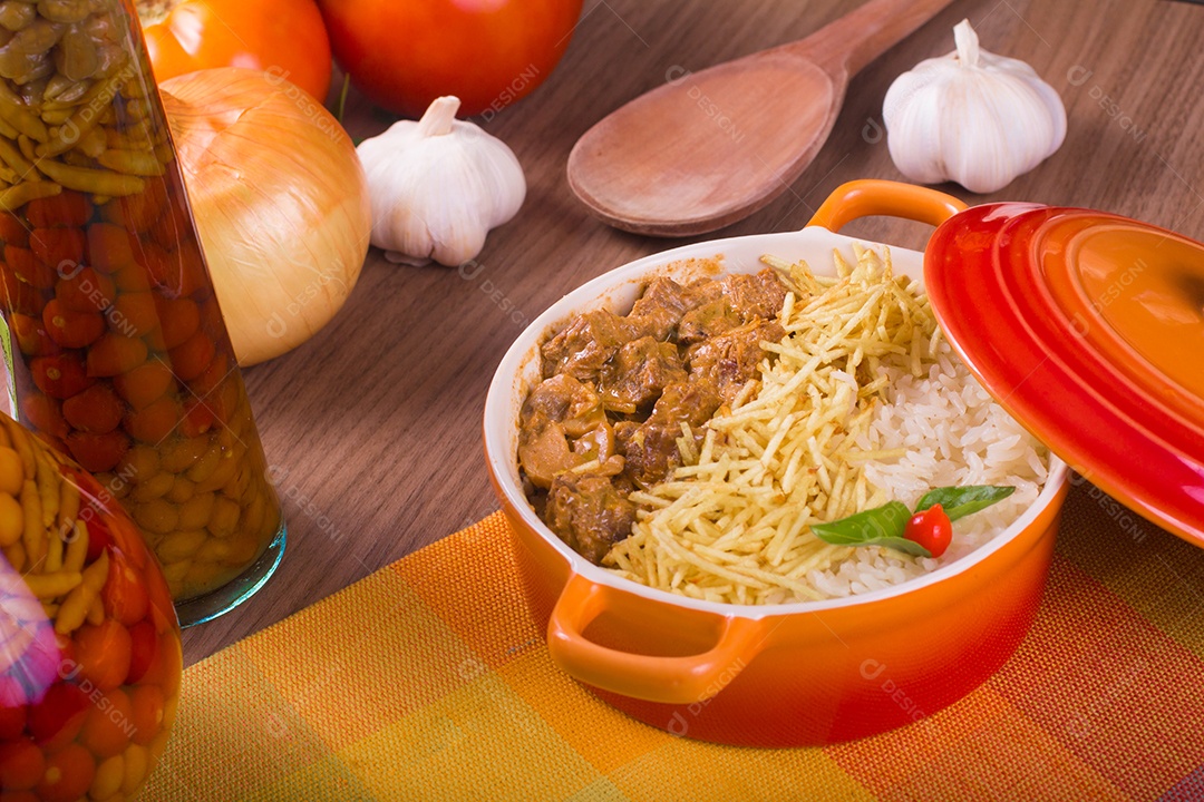 Strogonoff de carne na panela sobre uma mesa de madeira