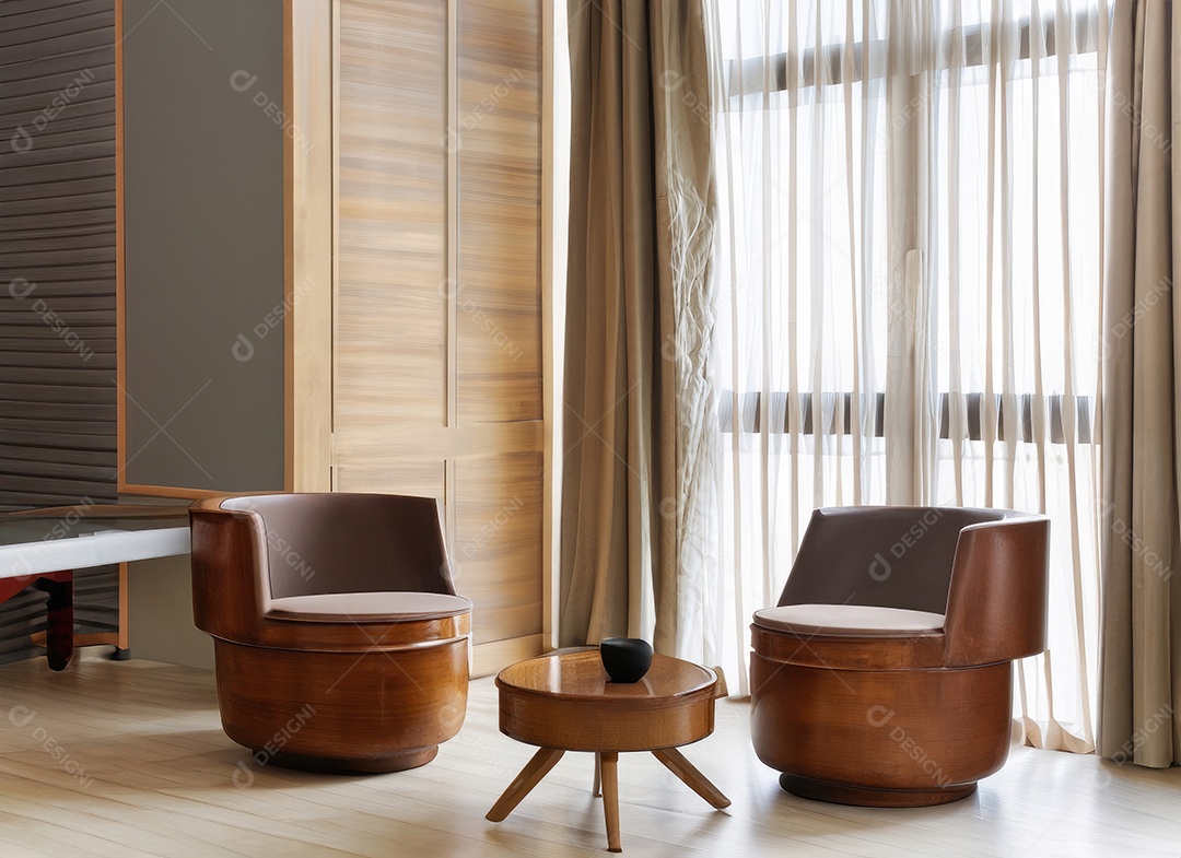 Duas cadeiras cilíndricas e mesa de centro redonda de madeira contra a janela perto do painel