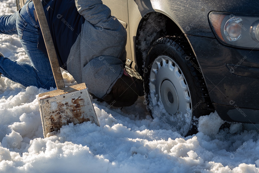 Homem que trabalha no carro preso na neve