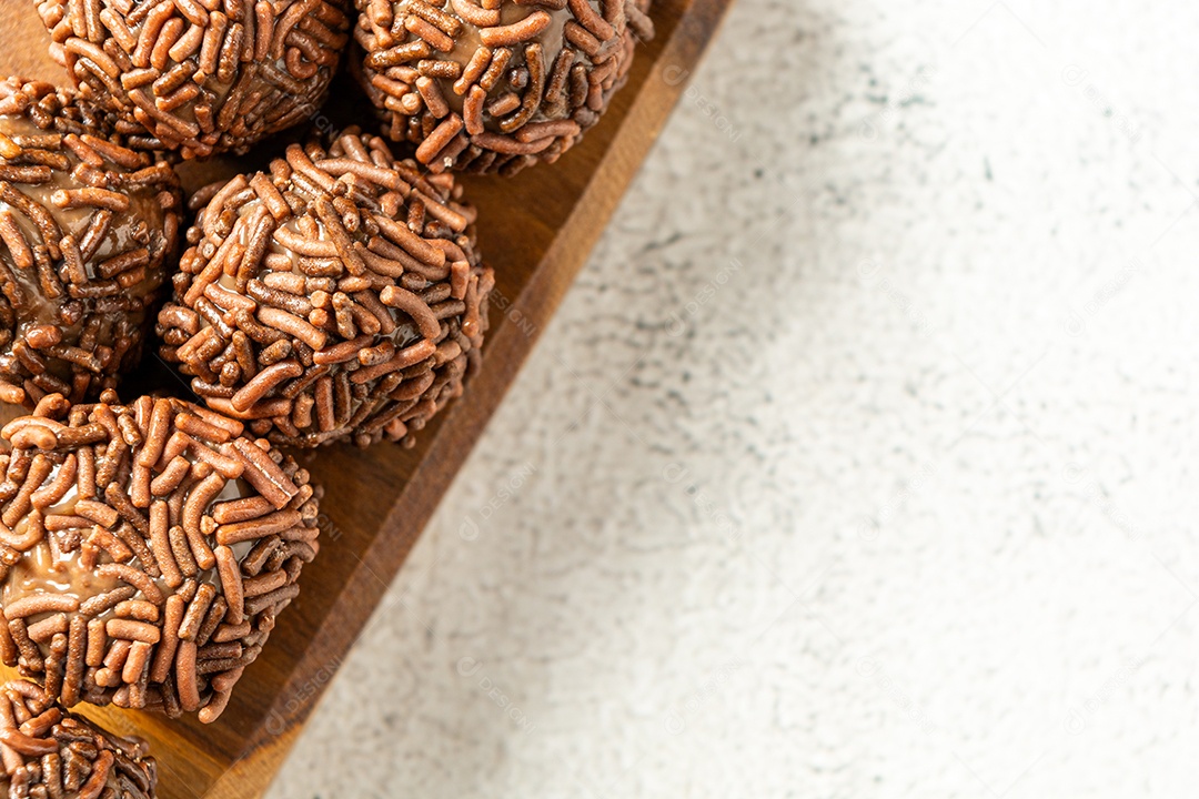 Brigadeiro de chocolate sobre uma tábua de madeira