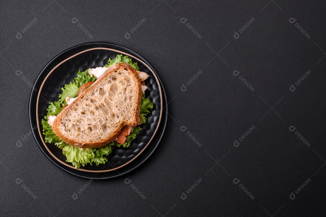 Sanduíche fresco e saboroso com salmão, abacate e sementes de gergelim e linho sobre um fundo escuro de concreto