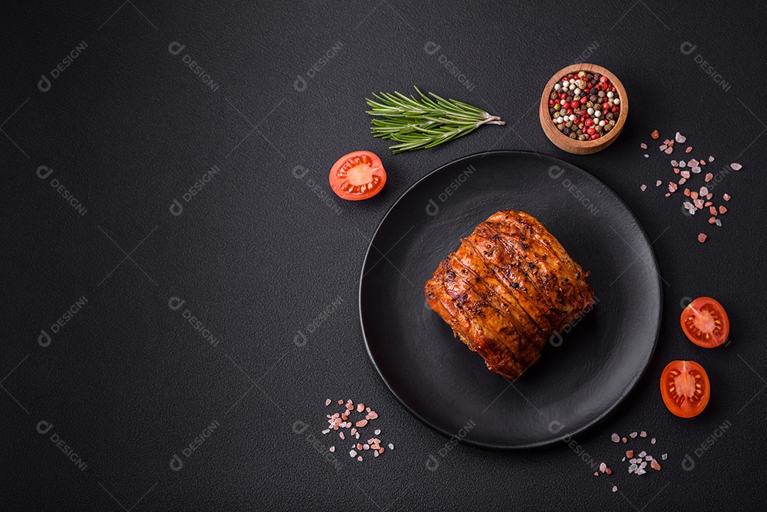 Deliciosa carne ou presunto fresco defumado com especiarias e ervas sobre um fundo escuro de concreto