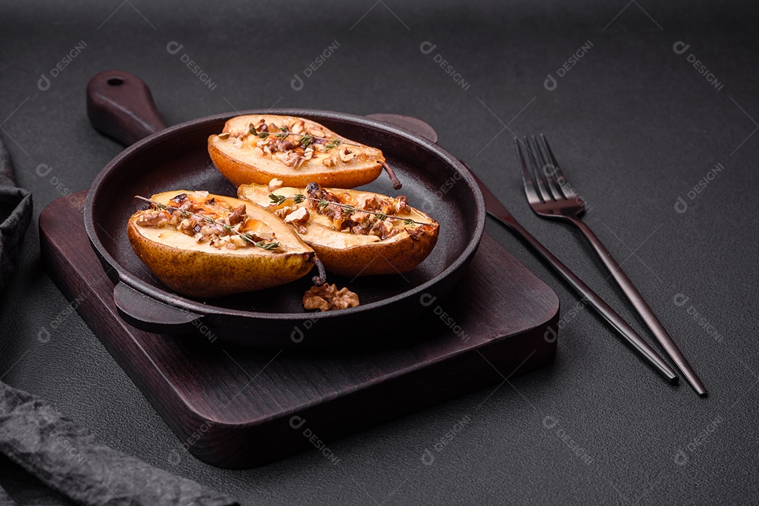 Deliciosa pêra assada com queijo dorblu, nozes e mel sobre um fundo de concreto texturizado. Prato vegetariano