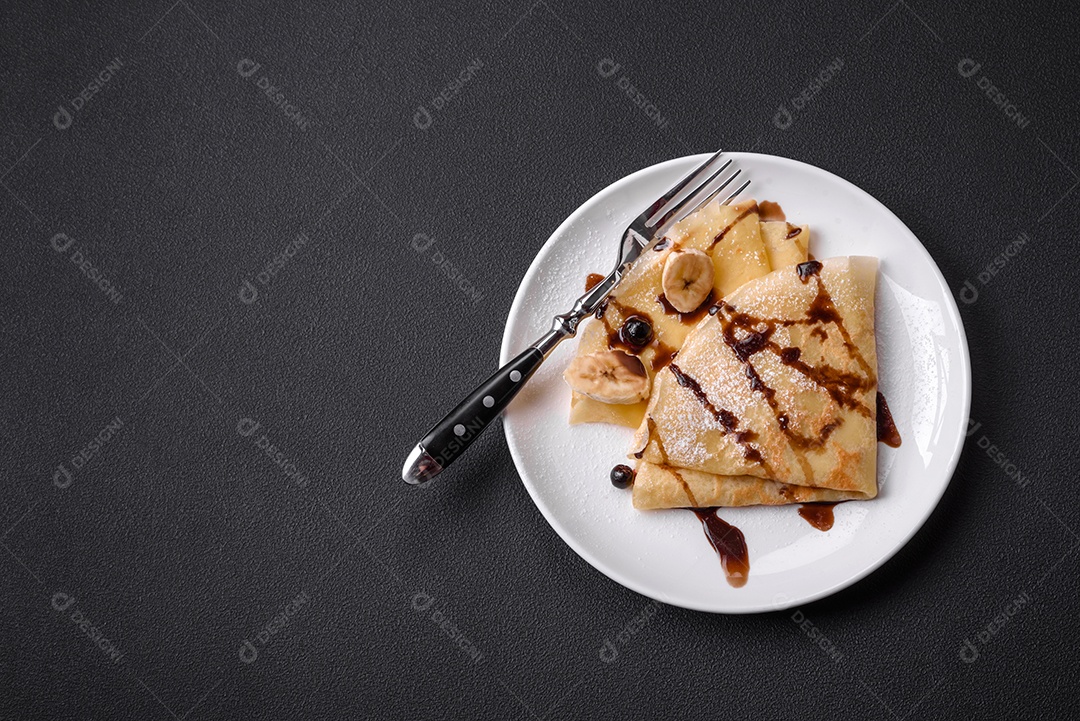 Deliciosas panquecas frescas com mel e frutas em um fundo de concreto texturizado. Comida saudável e útil