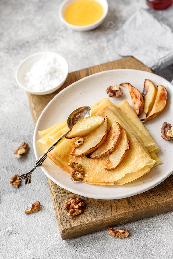 Deliciosas panquecas frescas com mel e frutas em um fundo de concreto texturizado. Comida saudável e útil