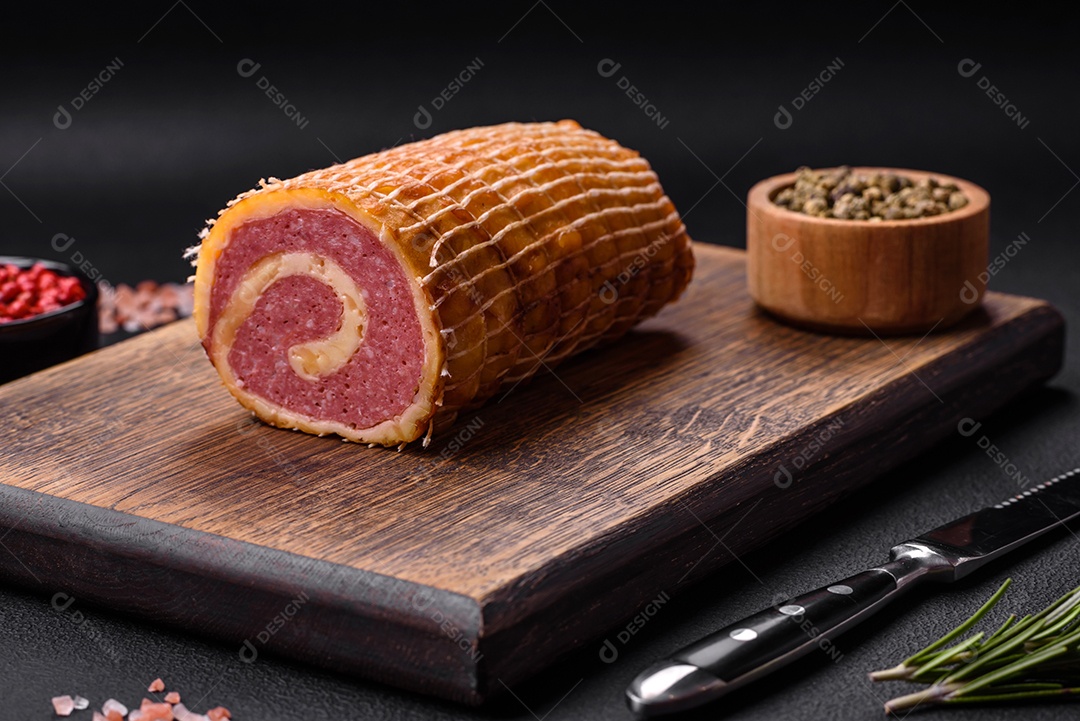 Rolo delicioso com carne, queijo, cogumelos, especiarias e ervas sobre um fundo de concreto texturizado escuro