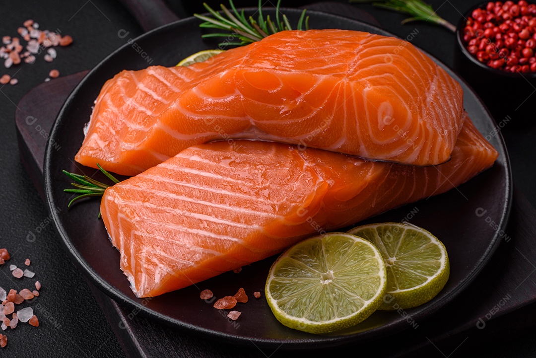 Filé de peixe vermelho fresco e saboroso com especiarias e ervas sobre um fundo escuro de concreto