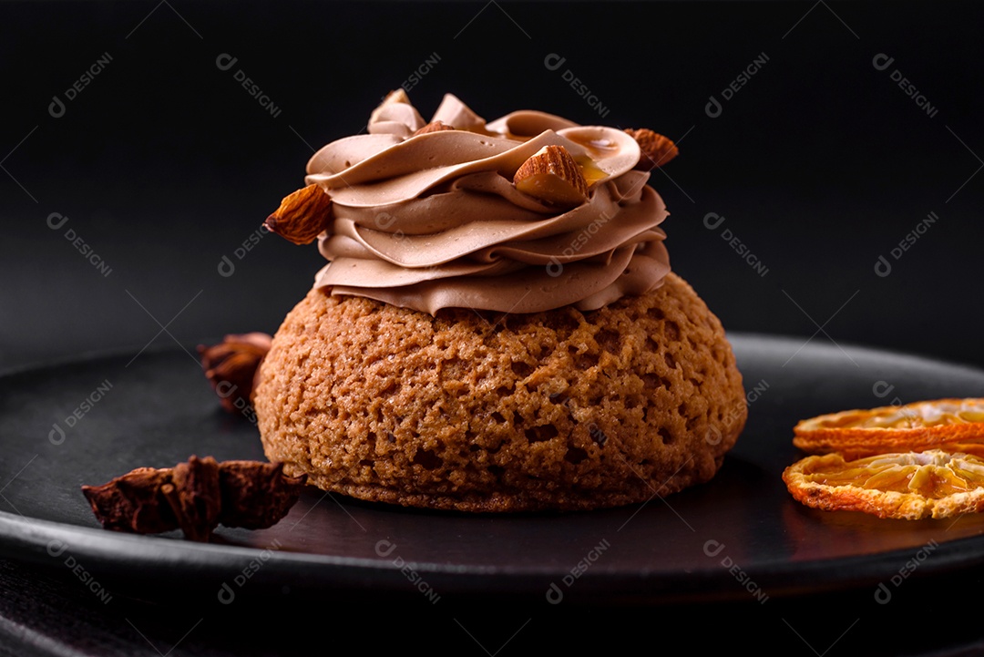 Delicioso bolo doce shu com creme e nozes sobre um fundo escuro de concreto