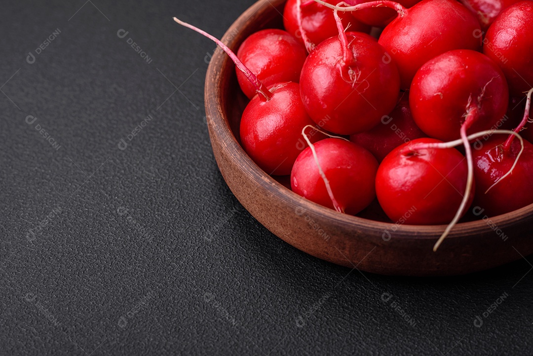 Delicioso rabanete vermelho cru fresco para fazer salada saudável em fundo escuro de concreto