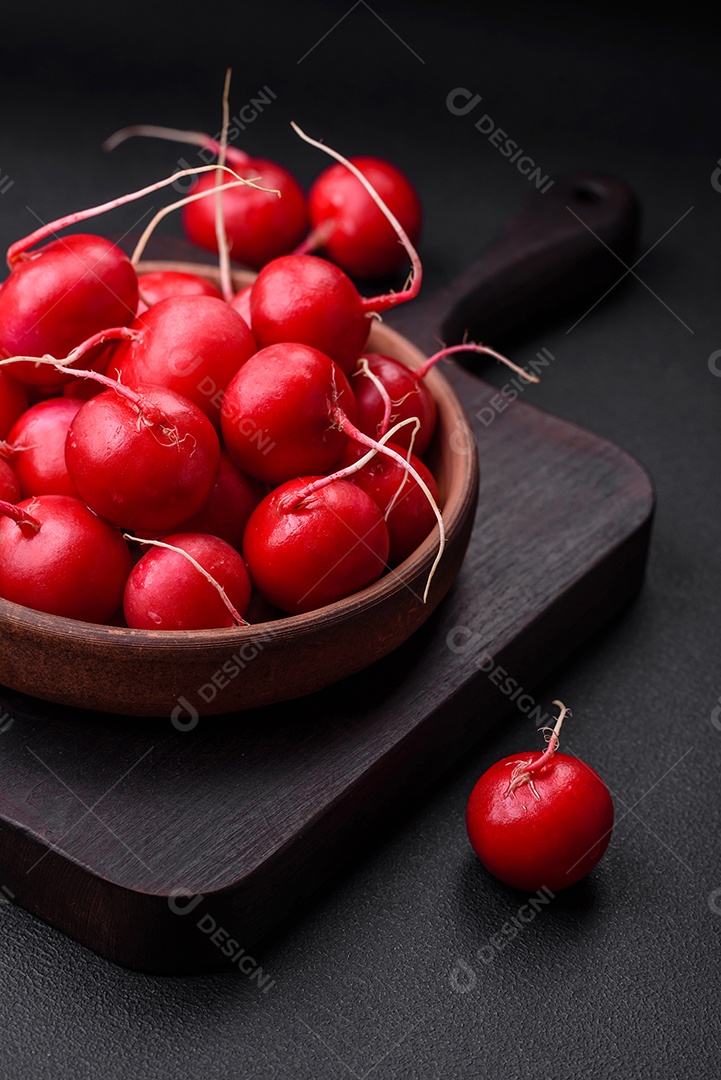 Delicioso rabanete vermelho cru fresco para fazer salada saudável em fundo escuro de concreto