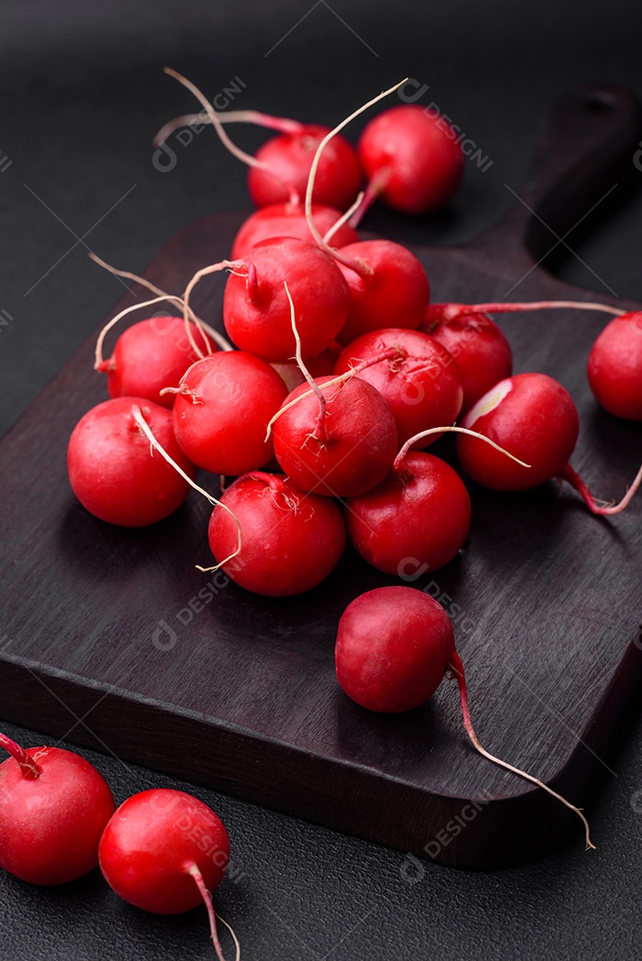 Delicioso rabanete vermelho cru fresco para fazer salada saudável em fundo escuro de concreto