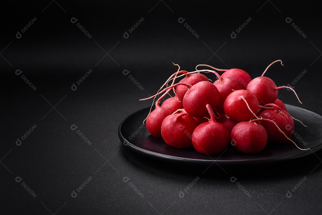 Delicioso rabanete vermelho cru fresco para fazer salada saudável em fundo escuro de concreto