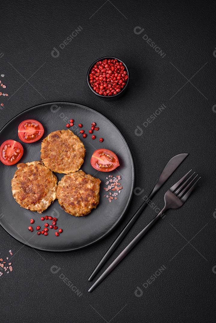 Deliciosas costeletas de peixe picado frito fresco com especiarias e ervas sobre um fundo escuro de concreto