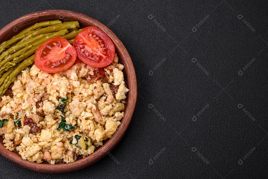 Deliciosa mistura com salmão, tomate seco, espinafre, especiarias e ervas em fundo escuro