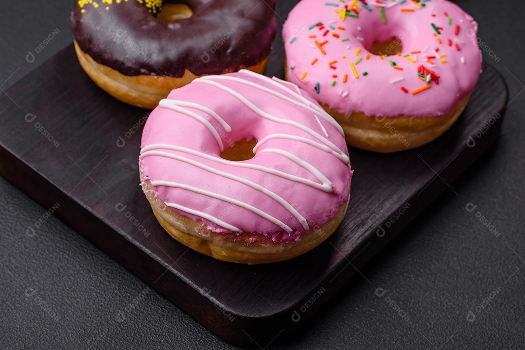 Delicioso donut com recheio de creme e nozes em um fundo escuro de concreto. Comida doce