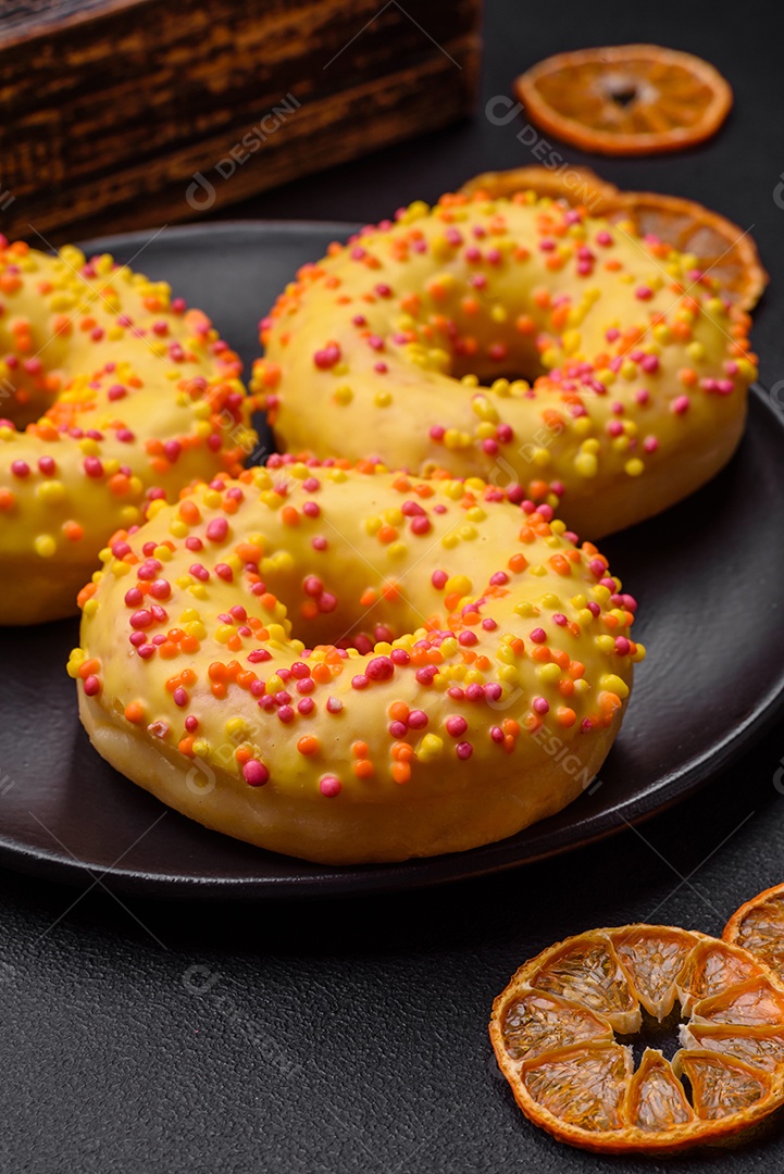 Deliciosos donuts frescos em esmalte amarelo com recheio de sabor de limão em fundo de concreto texturizado