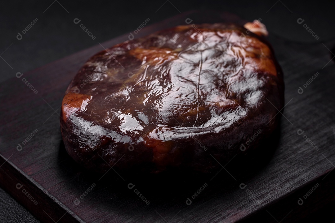 Delicioso basturma armênio defumado com especiarias e ervas cortadas em um fundo escuro de concreto