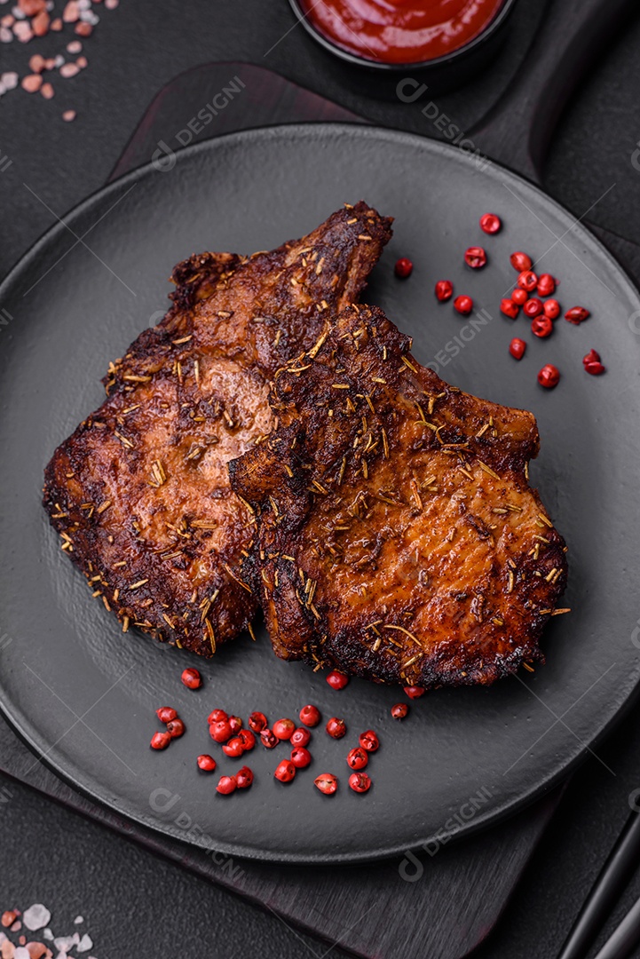 Deliciosas pernas de frango grelhado com especiarias e ervas em molho teriyaki sobre um fundo escuro de concreto