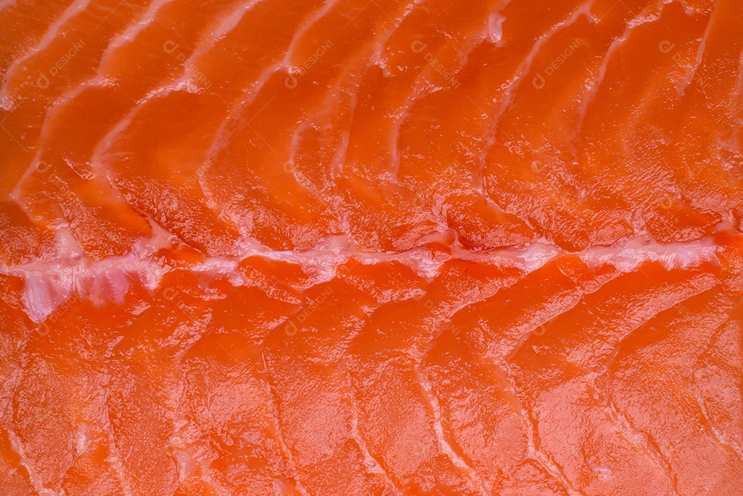 Filé de peixe vermelho salmão cru fresco com sal e especiarias sobre um fundo escuro de concreto