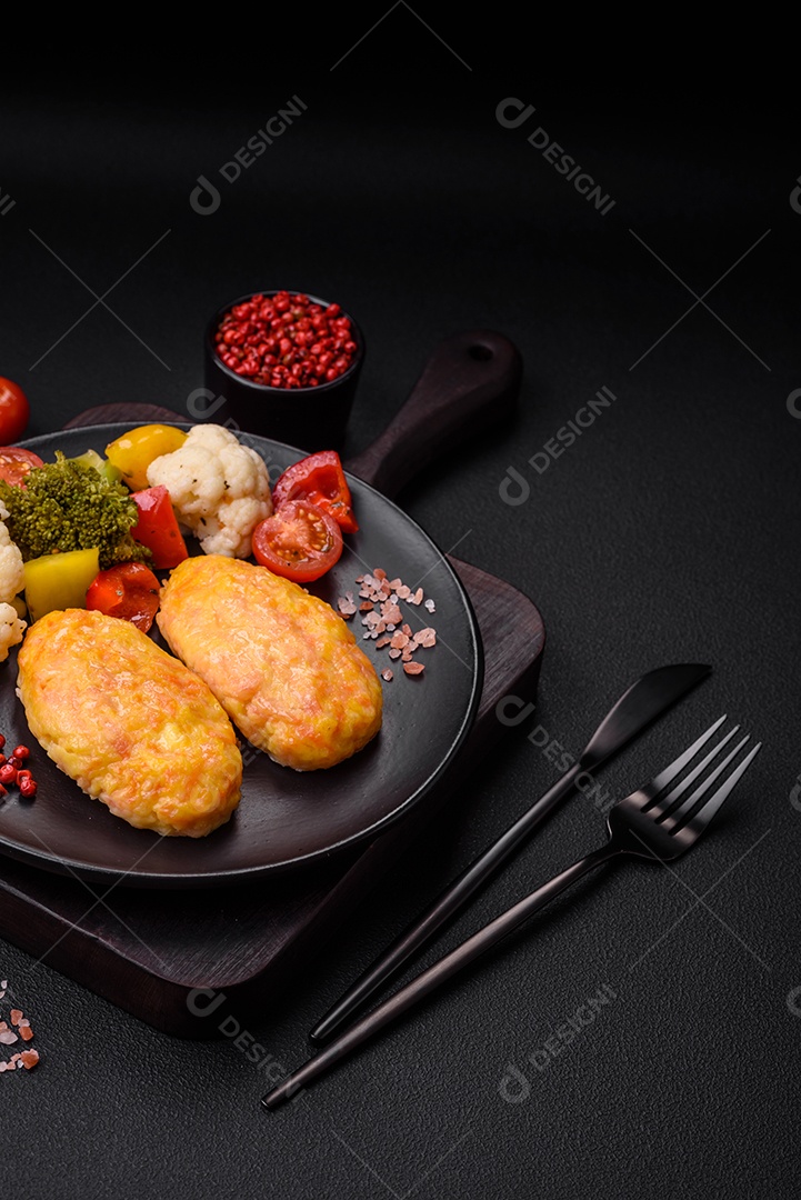 Deliciosas costeletas de vapor com cenoura, queijo, sal e especiarias sobre um fundo escuro de concreto