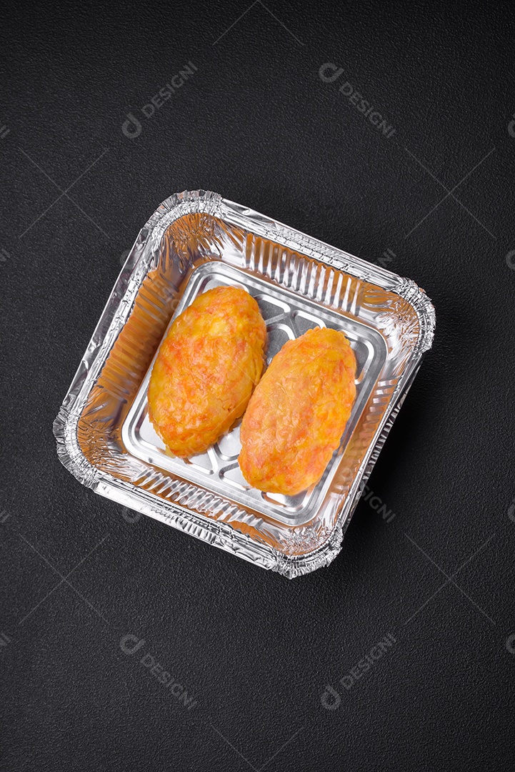 Deliciosas costeletas de vapor com cenoura, queijo, sal e especiarias sobre um fundo escuro de concreto