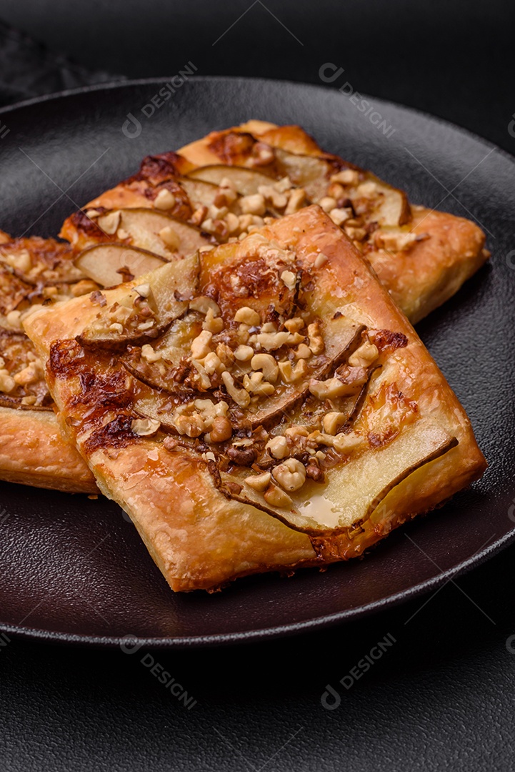 Deliciosa torta doce fresca ou pizza com pera, queijo brie, mel e nozes sobre um fundo escuro de concreto
