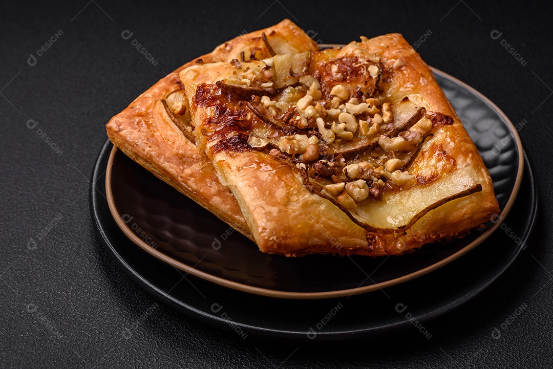 Deliciosa torta doce fresca ou pizza com pera, queijo brie, mel e nozes sobre um fundo escuro de concreto