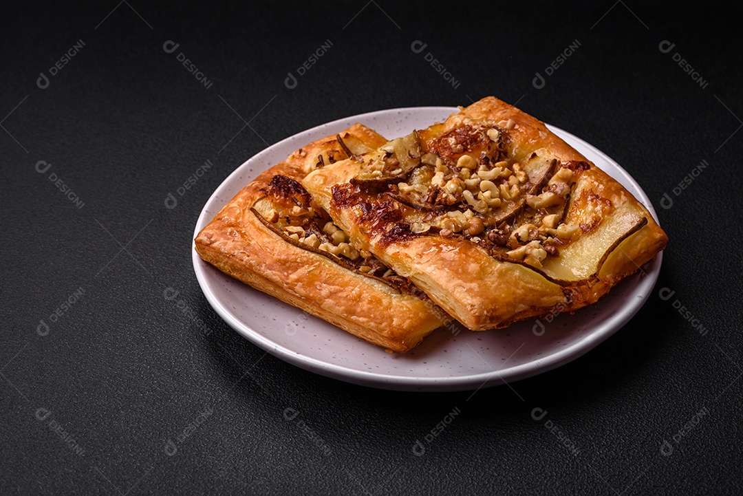 Deliciosa torta doce fresca ou pizza com pera, queijo brie, mel e nozes sobre um fundo escuro de concreto