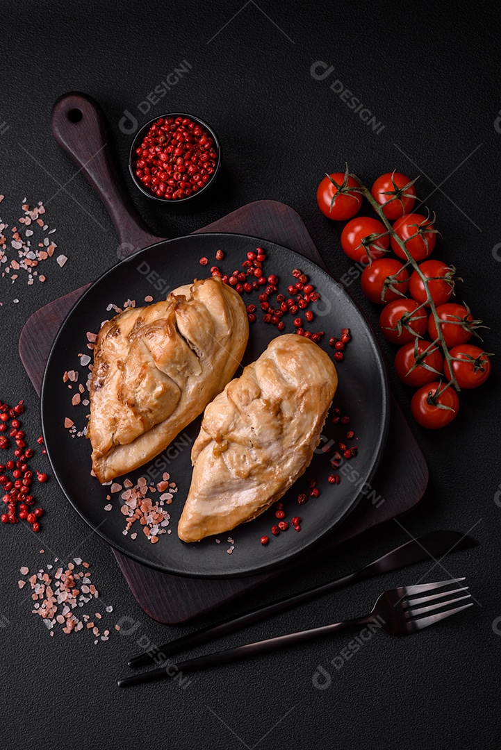 Delicioso bife com sal, especiarias e ervas em uma placa cerâmica sobre um fundo escuro de concreto