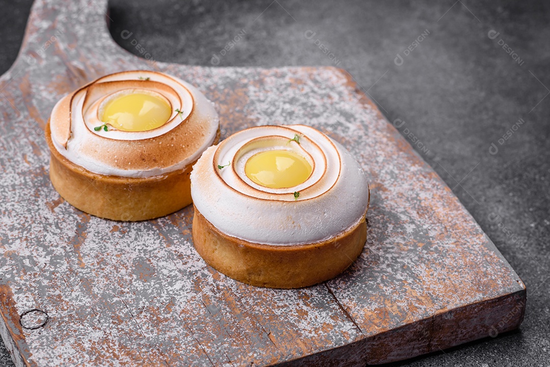 Deliciosa torta com recheio cítrico e creme de nozes sobre fundo de concreto texturizado