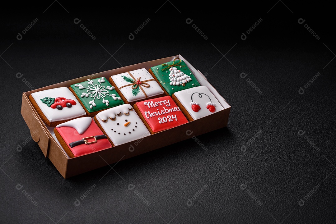 Lindos biscoitos de gengibre de Natal coloridos para o design e decoração da mesa festiva sobre um fundo de concreto texturizado