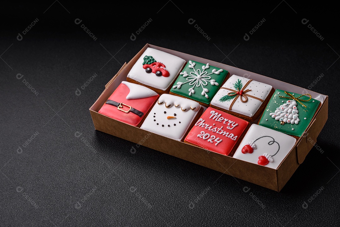 Lindos biscoitos de gengibre de Natal coloridos para o design e decoração da mesa festiva sobre um fundo de concreto texturizado