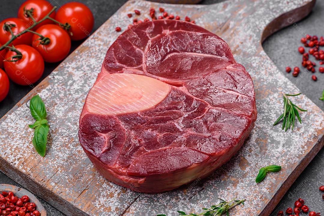 Bife de ossobuco de carne fresca com sal, especiarias e ervas em fundo de concreto texturizado