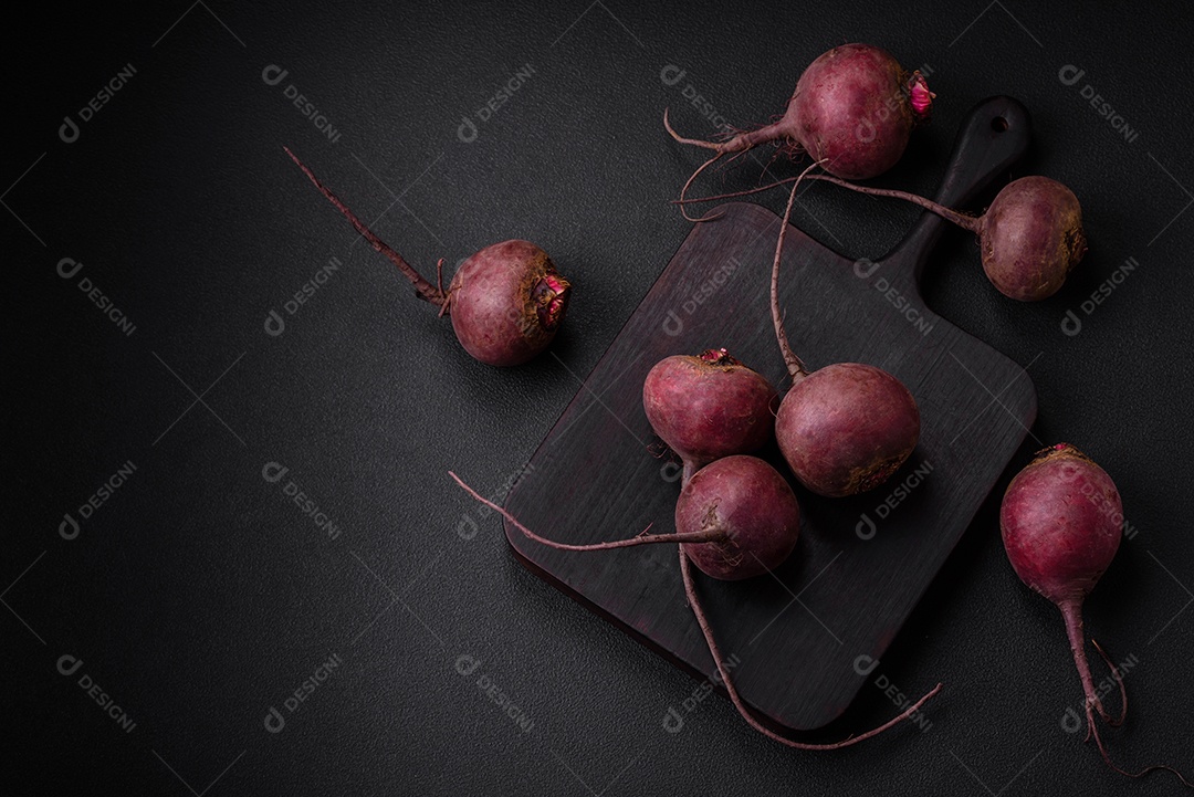 Beterraba crua fresca em forma de tubérculos sobre um fundo de concreto texturizado. Ingredientes Vegetarianos