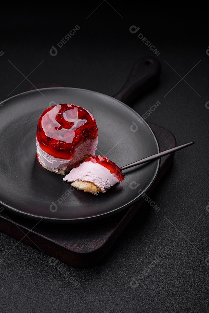 Delicioso bolo de queijo doce fresco com frutas e geleia de cor vermelha sobre um fundo escuro de concreto