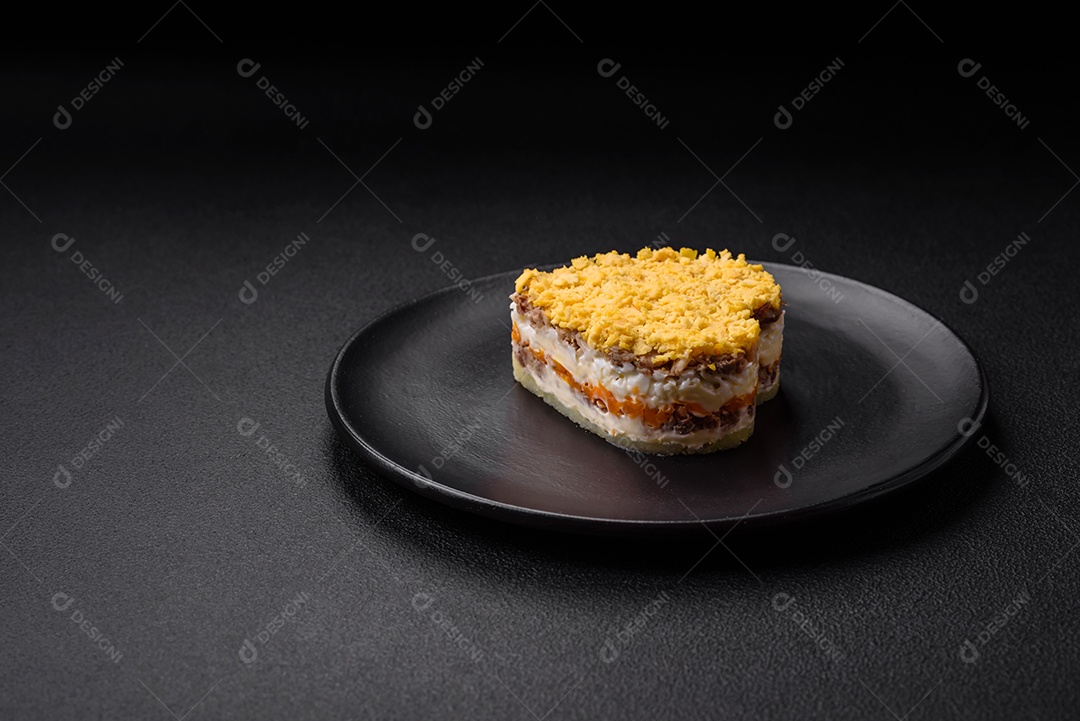 Deliciosa salada de mimosa fresca com conservas de peixe, ovo, moinese, queijo, sal e especiarias sobre fundo escuro de concreto