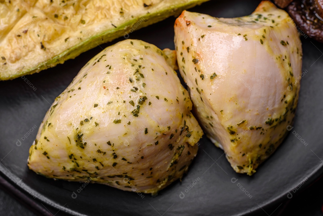 Deliciosos legumes grelhados, abobrinha, berinjela, pimentão e cogumelos com sal, especiarias e ervas sobre um fundo escuro de concreto