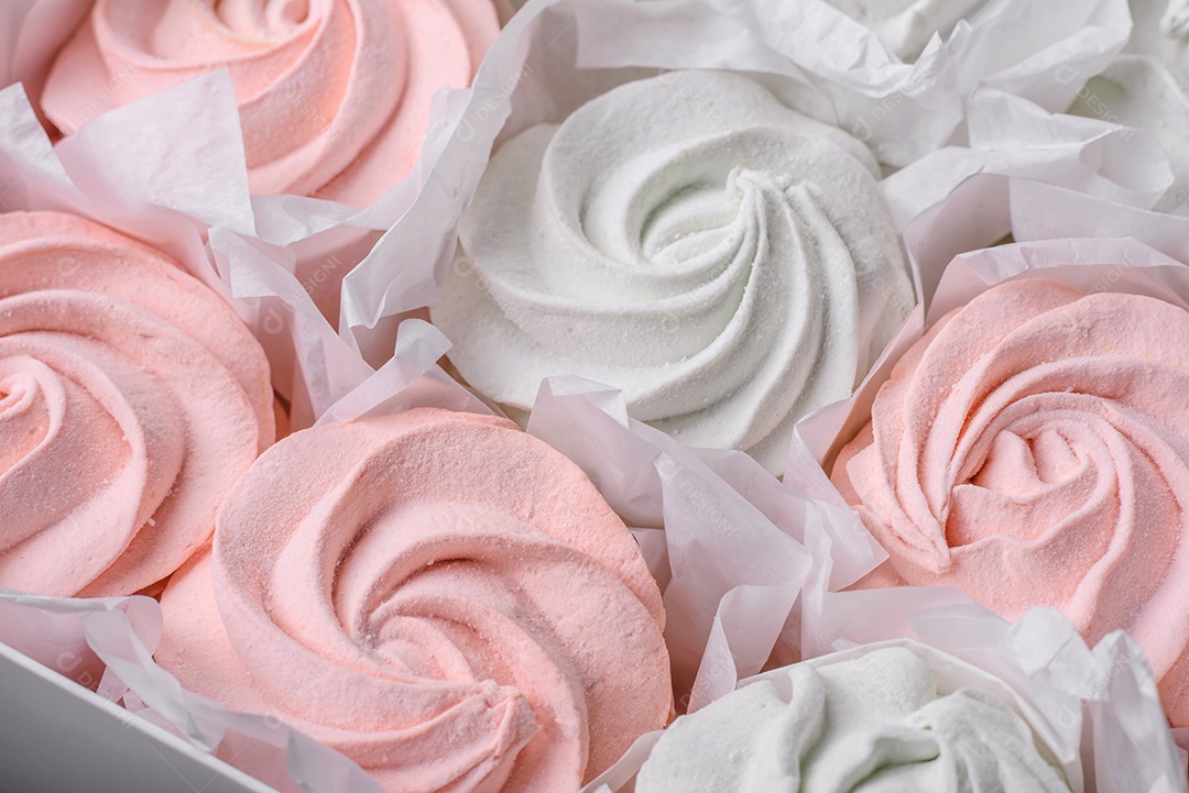 Delicioso marshmallow doce multicolorido em um fundo escuro de concreto. Doces saudáveis ​​para a mesa de jantar