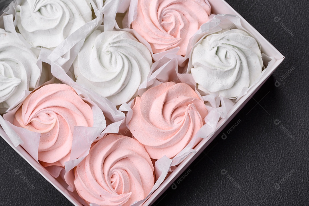 Delicioso marshmallow doce multicolorido em um fundo escuro de concreto. Doces saudáveis ​​para a mesa de jantar